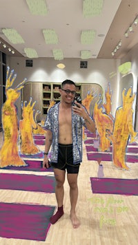 a man is taking a selfie in a yoga studio